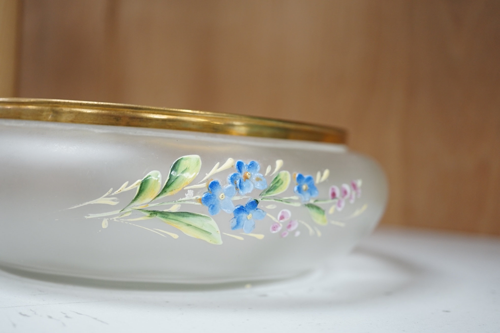 A Bohemian forget-me-not enamelled glass box and cover 18cm diameter. Condition - poor to fair, hinge broken.